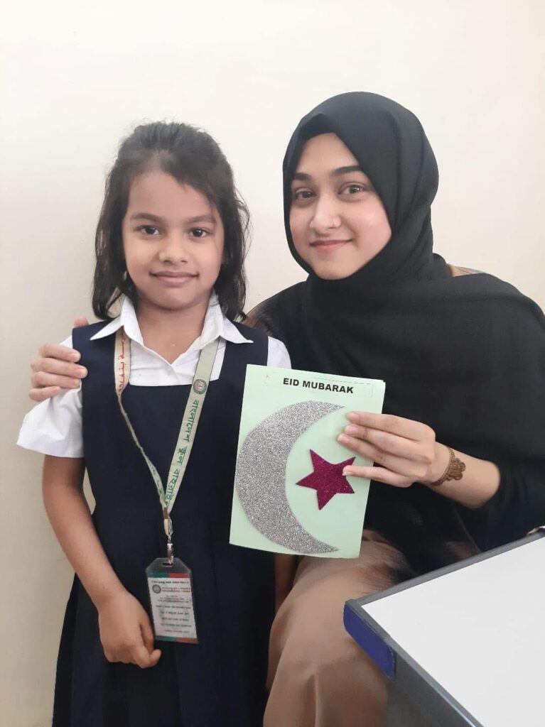 A teacher and student celebrating Eid Mubarak